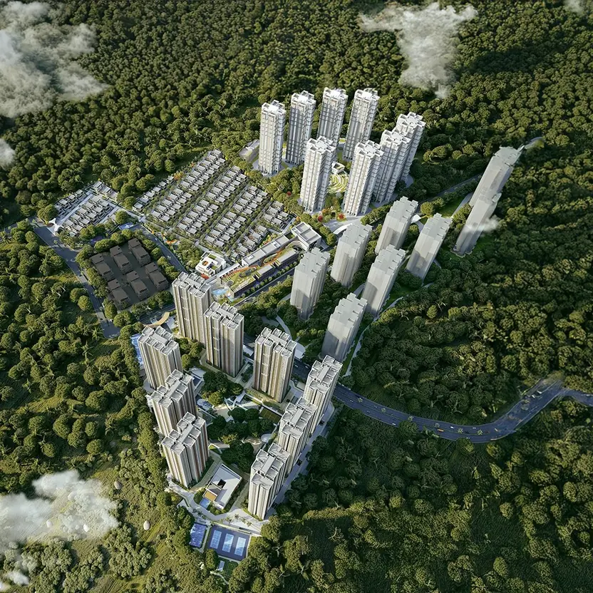 An aerial view of Aparna Deccan Town, its towers rising among green woodland