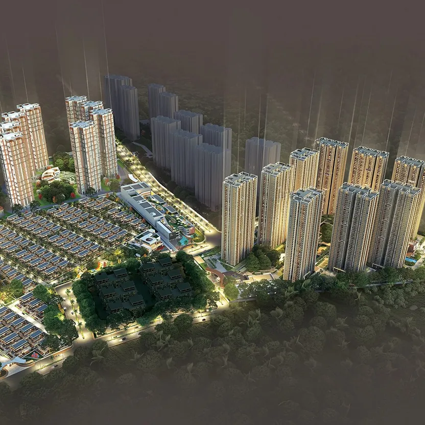 An aerial view of Aparna Deccan Town at dusk, its towers lit